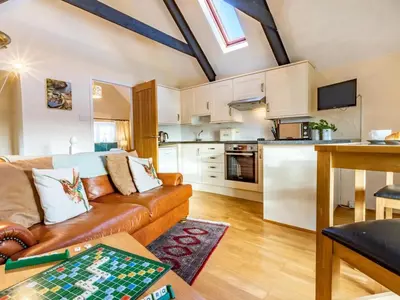a living room with a couch and a kitchen at 1 Bed in Helston oc-41377 in Cury