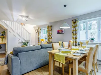 a living room with a blue couch and a table at 2 Bed in Redruth oc-86269 in Gwennap