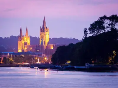 a church with a clock tower next to a body of water at 2 Bed in Truro oc-ljasm in Saint Allen