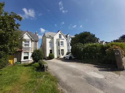a house with a white car parked in a driveway at The Fieldings in Truro