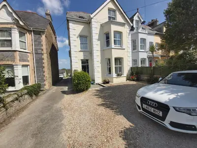 a white car parked in front of a house at The Fieldings in Truro