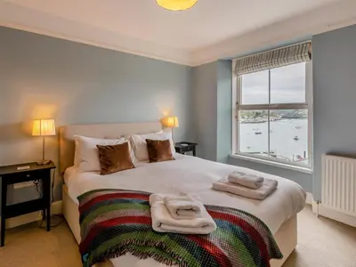 a bedroom with a bed with two towels on it at 4 Bed in Polruan oc-pc044 in Fowey