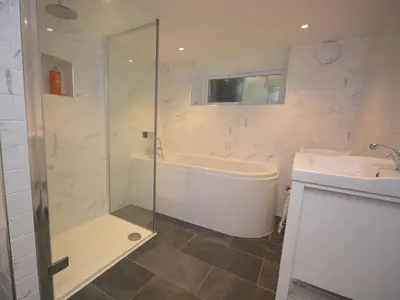 a bathroom with a shower and a tub and a sink at 3 Bed in Polruan oc-pc012 in Polruan