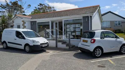 two white cars parked in front of a house at E04 Fresno, Riviere Towans in Hayle