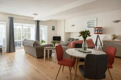 a living room with a couch and a table at Stone's Throw - 2 Bed Apartment Centre of Falmouth in Falmouth