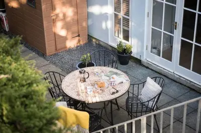 a table and chairs sitting on a patio at Stone's Throw - 2 Bed Apartment Centre of Falmouth in Falmouth