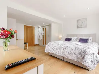 a bedroom with a bed and a desk with a keyboard at 4 Bed in Callington oc-54343 in Linkinhorne