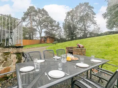 a table with plates and glasses on top of a table at 4 Bed in Callington oc-54343 in Linkinhorne