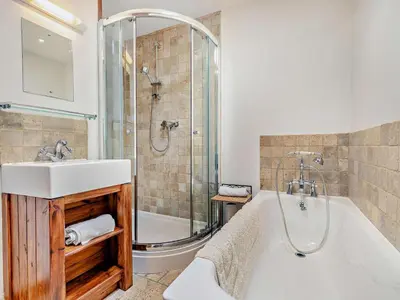 a bathroom with a tub and a sink and a shower at 2 Bed in Launceston oc-02043 in North Petherwin