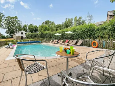 a swimming pool with chairs and a table and a tablektop at 2 Bed in Launceston oc-02043 in North Petherwin