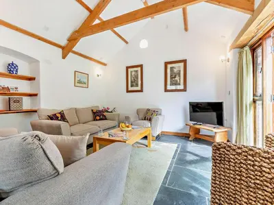 a living room with a couch and a table at 2 Bed in Launceston oc-02043 in North Petherwin