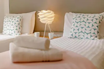 a bedroom with two beds with a lamp and pillows at 2 Bed in St. Ives oc-92928 in Carbis Bay