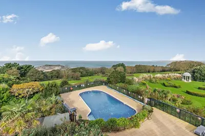 an aerial view of a swimming pool in a garden at 2 Bed in St. Ives oc-92928 in Carbis Bay