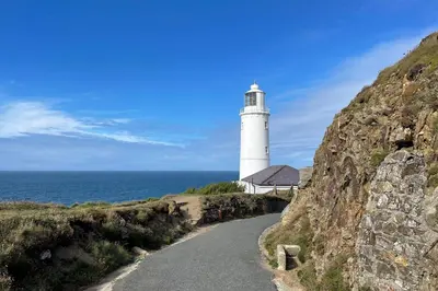a lighthouse on a hill next to the ocean at Hillview in Little Petherick
