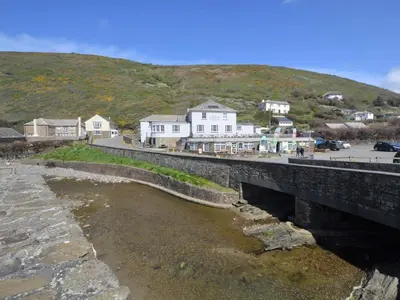 a bridge over a river with houses on a hill at 3 Bed in Bude oc-09117 in Saint Gennys