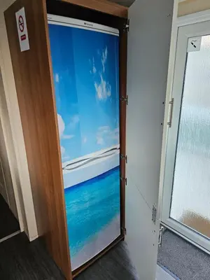 a door with a window with a view of the ocean at 113 Caravan at meadow lakes in St Austell