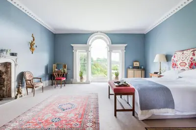 a bedroom with a bed and a large window at Lostwithiel Manor in Braddock