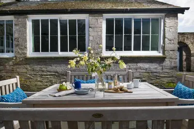 a wooden table in front of a house at Lostwithiel House in Braddock
