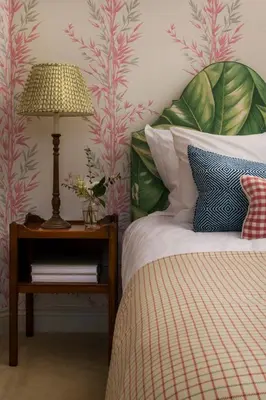 a bedroom with a bed and a table with a lamp at Lostwithiel House in Braddock