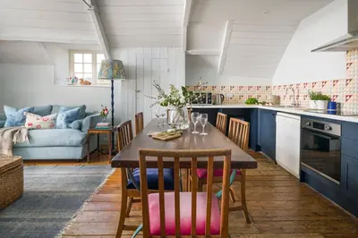a kitchen and dining room with a table and chairs at Lostwithiel House in Braddock
