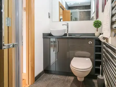 a bathroom with a toilet and a sink at Rooftops in St Ives