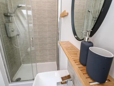 a bathroom with a shower and a toilet and a sink at 20 Bishops Way in Falmouth