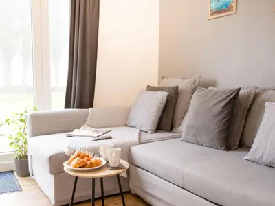 a living room with a couch and a table with a bowl of fruit at Chalet Hot Tub Lodge 1 by Interhome in Helston