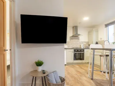 a tv hanging on a wall in a kitchen at Chalet Hot Tub Lodge 1 by Interhome in Helston