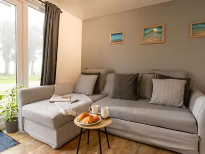 a living room with a couch and a table at Chalet Lodge 3 by Interhome in Helston