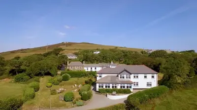 an aerial view of a large white house on a hill at Beacon Hotel Self Catering Apartment in St. Agnes