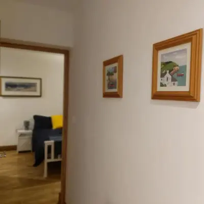 a living room with three pictures on the wall at Heart of Kernow Holidays in Bugle