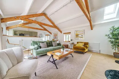 a living room with couches and a table at The Granary in Camelford
