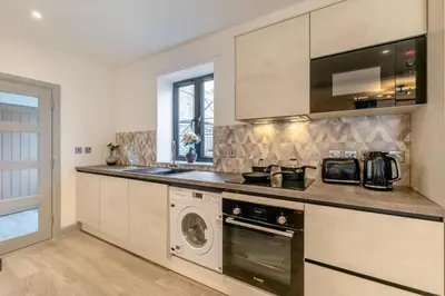 a kitchen with a washer and dryer and a microwave at 2 Bed in St. Ives oc-s28155 in St Ives