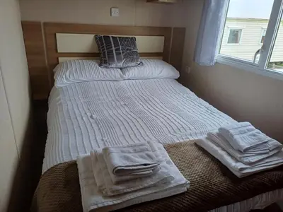 a small bedroom with two beds with towels on them at 20 in Trelaske
