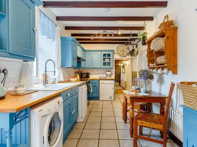 a blue kitchen with a sink and a dishwasher at 3 Bed in Newquay oc-82369 in Mitchell