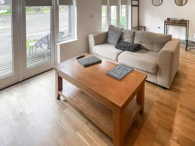 a living room with a couch and a coffee table at Trebellan in Porthtowan