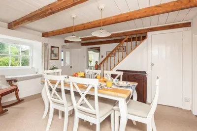 a dining room with a table and chairs at Blue Cottage - 3 bedroom cottage in Feock in Feock