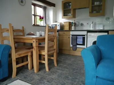 a kitchen with a table and chairs in a kitchen at Siblyback Cottage in Launceston