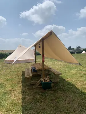 a tent and a bench in a field at Rescorla Retreats - Ivory in St Austell