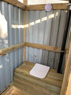 a white toilet sitting on top of a wooden platform at Rescorla Retreats - Ivory in St Austell