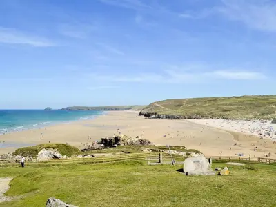 a beach with a bunch of people on the sand at Beach House in Perranporth
