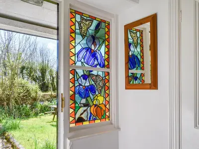 a door with a stained glass window on it at Nessa Cottage - Uk47087 in Davidstow