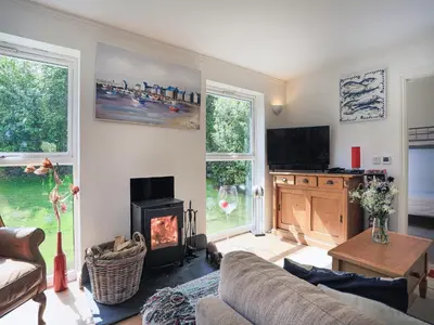a living room with a couch and a fireplace at 31 Lower Elms in Saint Minver