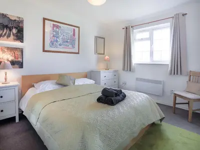 a bedroom with a bed with a stuffed animal on it at 31 Lower Elms in Saint Minver