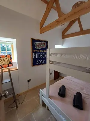 a bedroom with a bunk bed and a sign on the wall at Luxury countryside retreat with hot tub in Leedstown