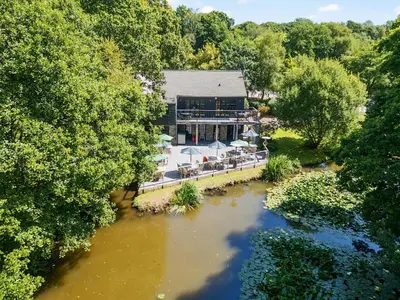 an aerial view of a building next to a river at 10 Stonerush Valley in Looe