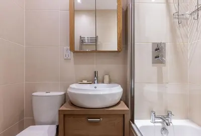 a bathroom with a sink and a toilet and a shower at 4 Fernhill in Carbis Bay