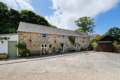 an old stone house with a driveway in front of it at River Cottage, Chypons Farm, Rural St Ives in Nancledra