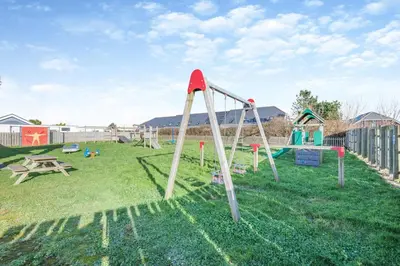 a playground with a slide in the grass at 2 Bed in St. Merryn oc-l29063 in St Merryn