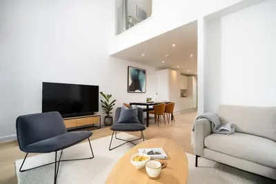 a living room with a couch and a table at Luxury Waterfront 3 Bedroom/3 Bathroom Townhouse in Hayle